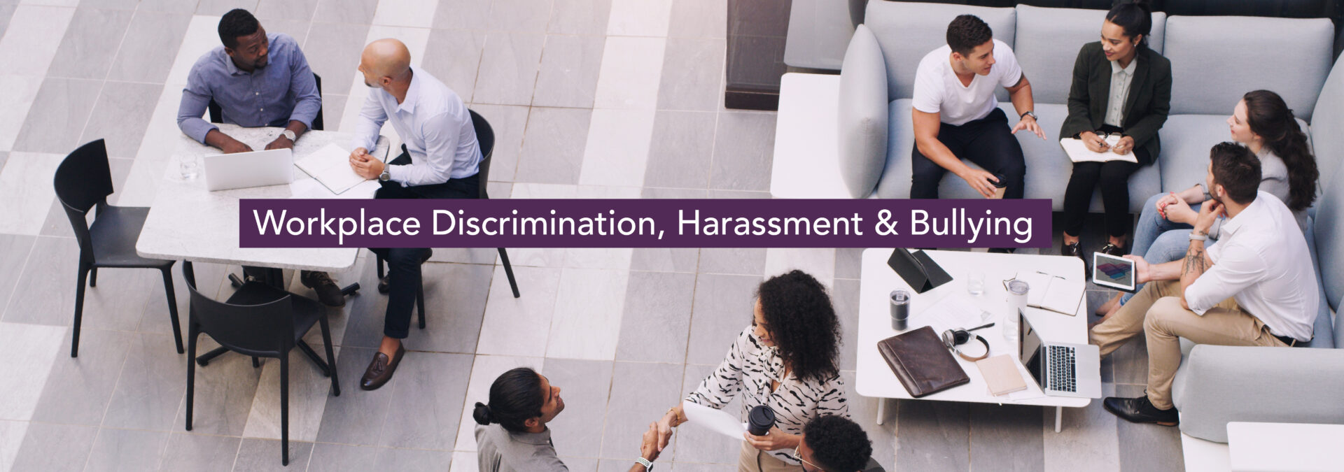 Workplace Discrimination, Harassment & Bullying. An overhead shot of young business professionals in a casual atmosphere